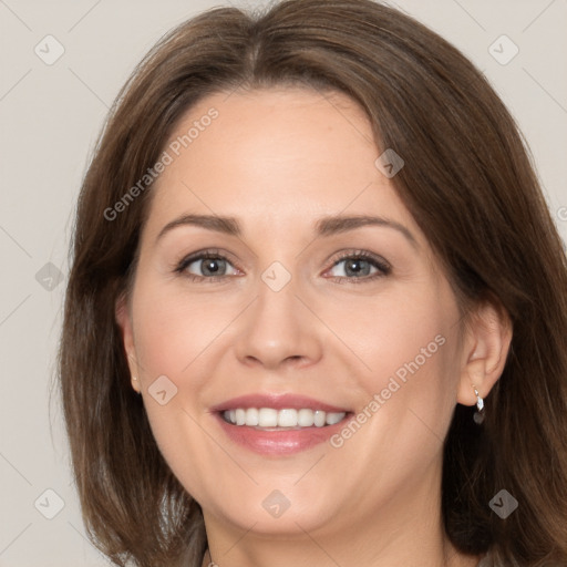 Joyful white adult female with medium  brown hair and grey eyes