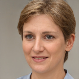 Joyful white adult female with medium  brown hair and grey eyes