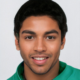 Joyful latino young-adult male with short  black hair and brown eyes