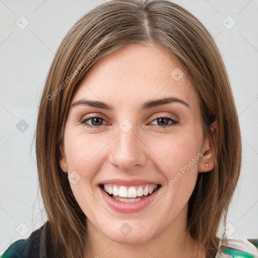 Joyful white young-adult female with medium  brown hair and green eyes