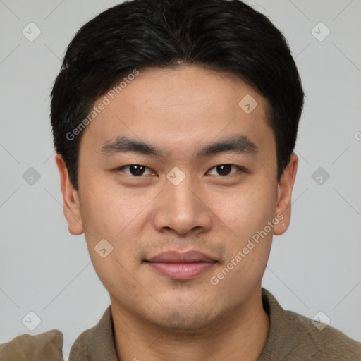 Joyful asian young-adult male with short  black hair and brown eyes