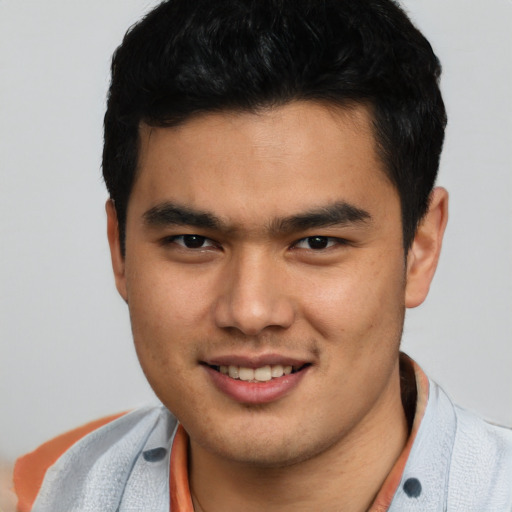 Joyful asian young-adult male with short  black hair and brown eyes