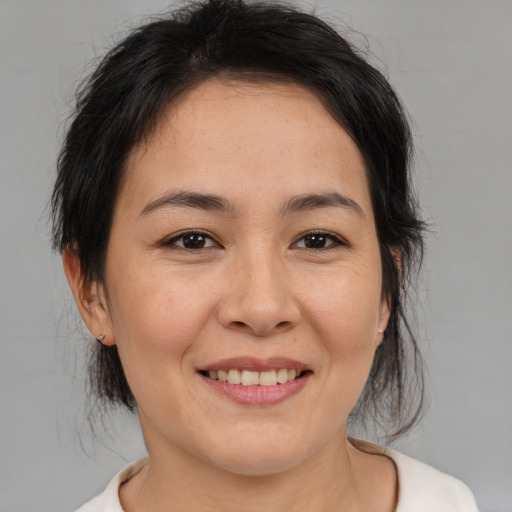 Joyful asian young-adult female with medium  brown hair and brown eyes
