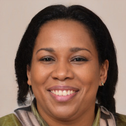 Joyful black adult female with medium  brown hair and brown eyes