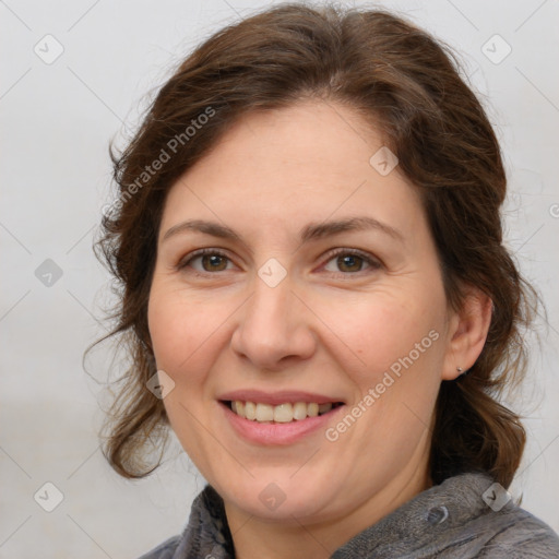 Joyful white adult female with medium  brown hair and brown eyes