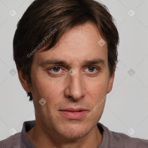 Joyful white adult male with short  brown hair and grey eyes