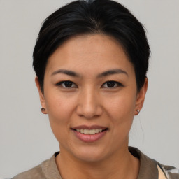 Joyful asian young-adult female with short  brown hair and brown eyes