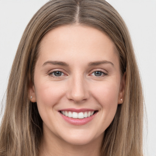 Joyful white young-adult female with long  brown hair and grey eyes