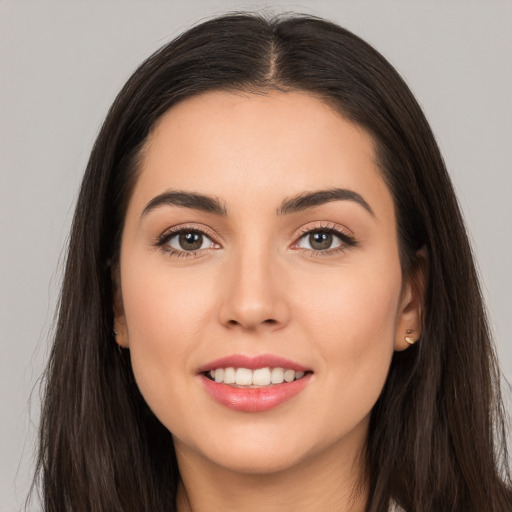 Joyful white young-adult female with long  brown hair and brown eyes