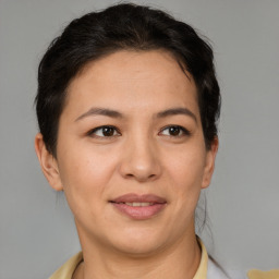 Joyful asian adult female with short  brown hair and brown eyes