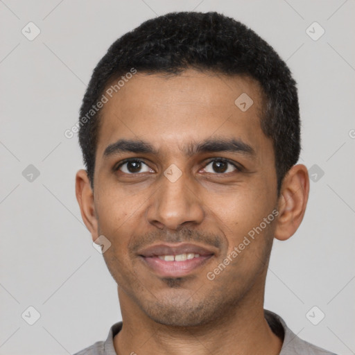 Joyful black young-adult male with short  black hair and brown eyes