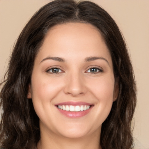 Joyful white young-adult female with long  brown hair and brown eyes