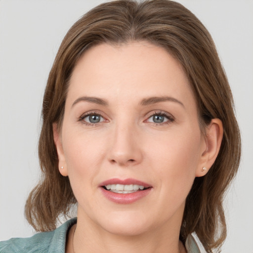 Joyful white young-adult female with medium  brown hair and grey eyes