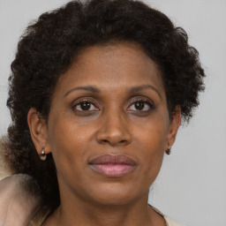 Joyful black adult female with short  brown hair and brown eyes