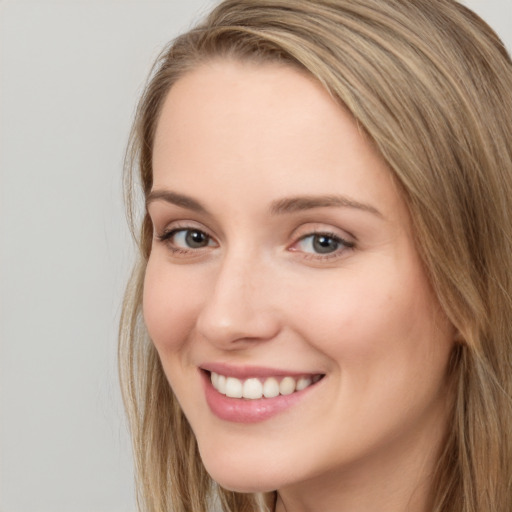 Joyful white young-adult female with long  brown hair and grey eyes