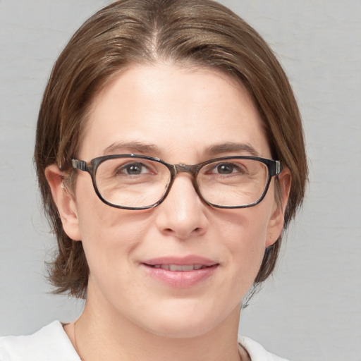 Joyful white adult female with medium  brown hair and blue eyes