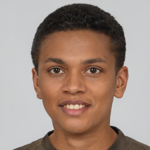 Joyful black young-adult male with short  brown hair and brown eyes