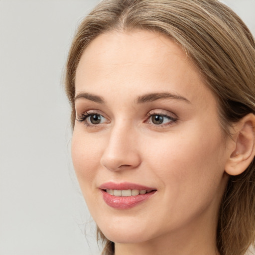 Joyful white young-adult female with long  brown hair and grey eyes