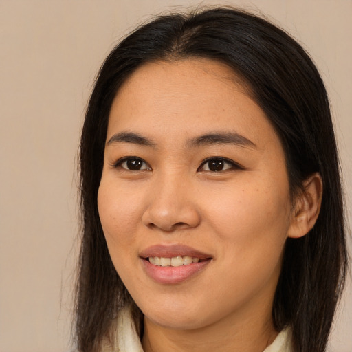 Joyful asian young-adult female with long  brown hair and brown eyes