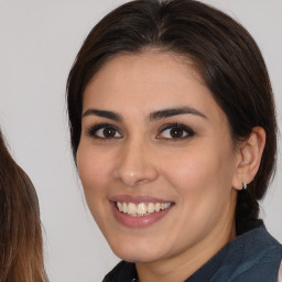 Joyful white young-adult female with medium  brown hair and brown eyes