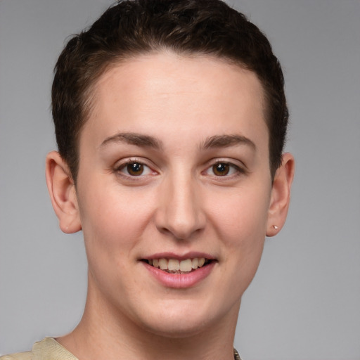 Joyful white young-adult female with short  brown hair and grey eyes