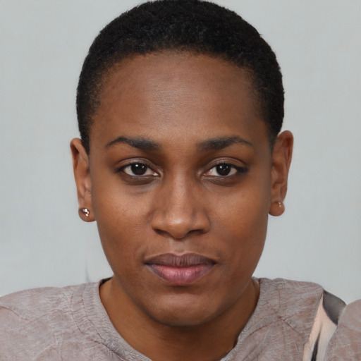 Joyful black young-adult female with short  black hair and brown eyes