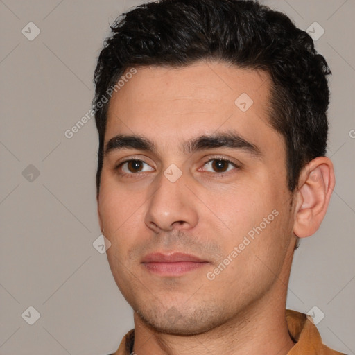 Joyful white young-adult male with short  black hair and brown eyes