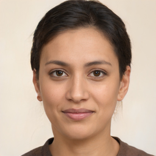 Joyful latino young-adult female with short  brown hair and brown eyes