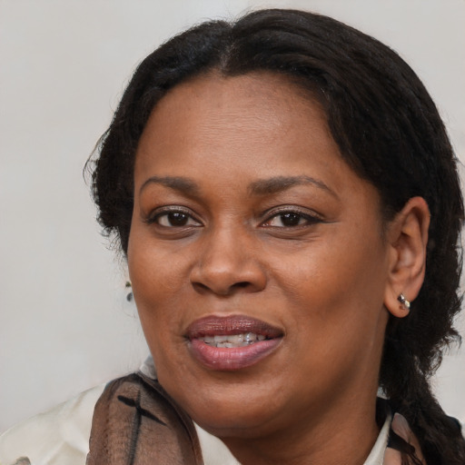 Joyful black adult female with medium  brown hair and brown eyes