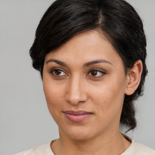 Joyful latino adult female with medium  brown hair and brown eyes