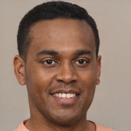 Joyful latino young-adult male with short  brown hair and brown eyes