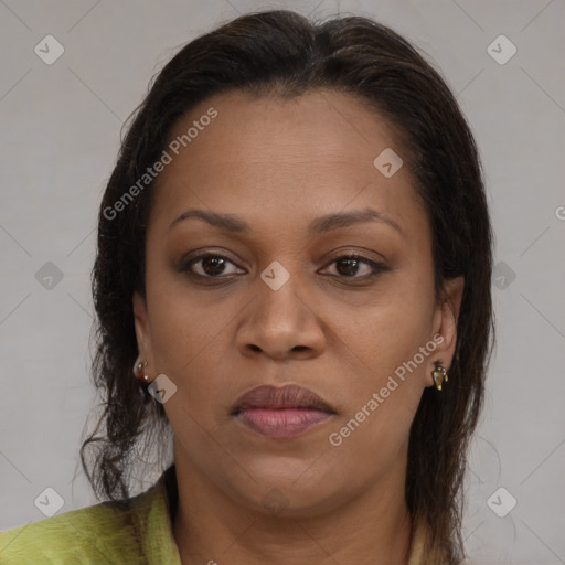 Joyful black young-adult female with long  brown hair and brown eyes