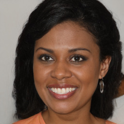 Joyful black young-adult female with medium  brown hair and brown eyes