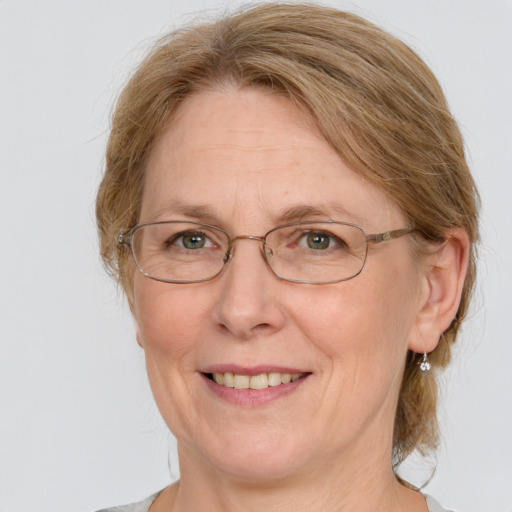 Joyful white middle-aged female with medium  brown hair and blue eyes