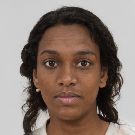Neutral black young-adult female with medium  brown hair and brown eyes