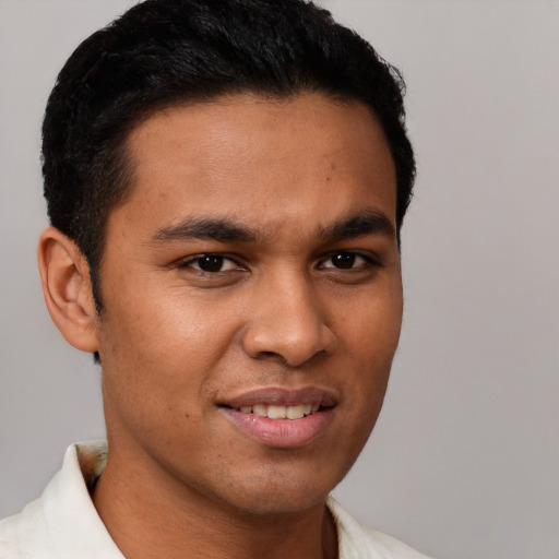 Joyful latino young-adult male with short  brown hair and brown eyes