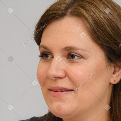 Joyful white adult female with medium  brown hair and brown eyes