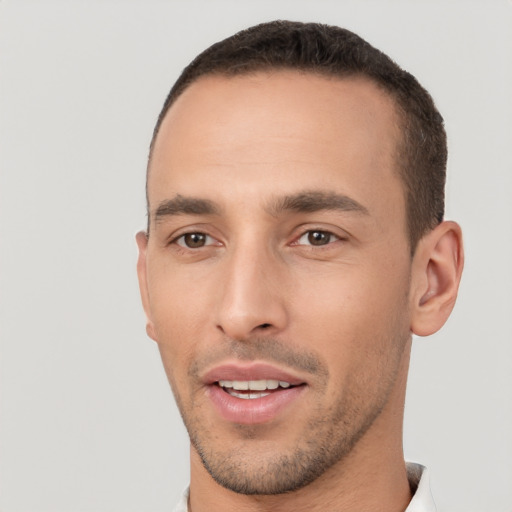 Joyful white young-adult male with short  brown hair and brown eyes