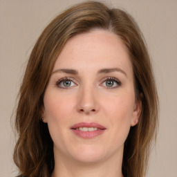 Joyful white young-adult female with long  brown hair and grey eyes