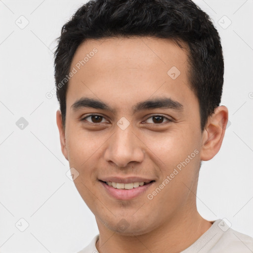 Joyful white young-adult male with short  black hair and brown eyes