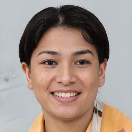Joyful asian young-adult female with short  brown hair and brown eyes