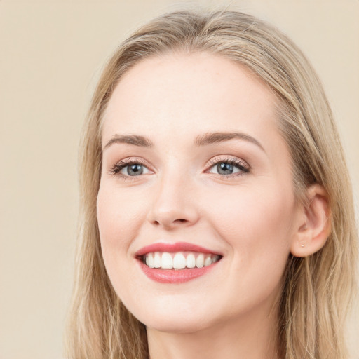 Joyful white young-adult female with long  brown hair and blue eyes