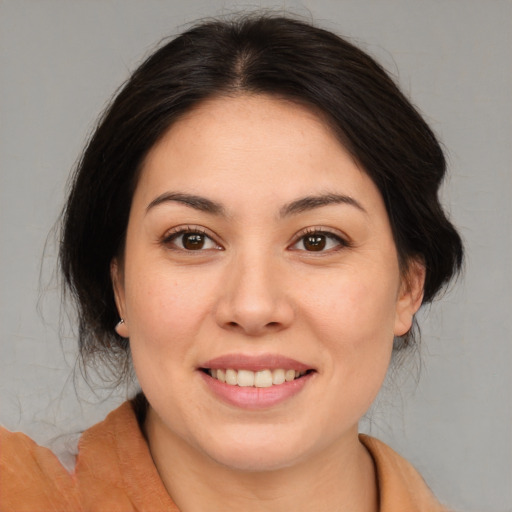 Joyful asian young-adult female with medium  brown hair and brown eyes