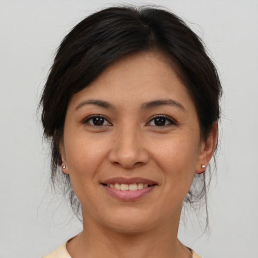 Joyful asian young-adult female with medium  brown hair and brown eyes