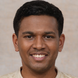 Joyful latino young-adult male with short  black hair and brown eyes