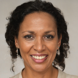 Joyful black adult female with medium  brown hair and brown eyes