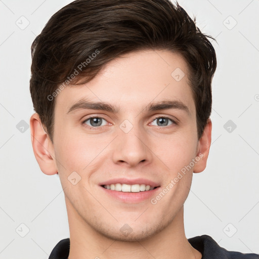 Joyful white young-adult male with short  brown hair and grey eyes