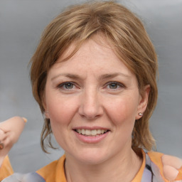 Joyful white adult female with medium  brown hair and grey eyes