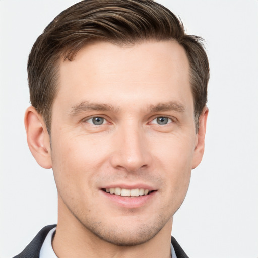 Joyful white young-adult male with short  brown hair and grey eyes