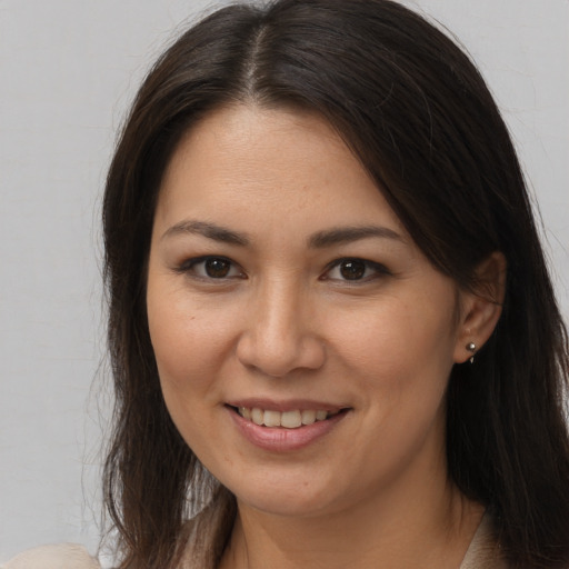 Joyful white young-adult female with long  brown hair and brown eyes